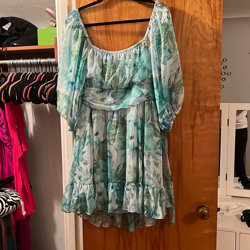Green floral mini dress with ruffle bottom tie back and puff sleeves